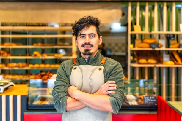 istock Baker standing proud in a modern artisan bakery shop 2187987240