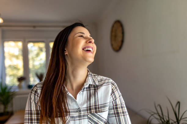 istock Smiling Woman Enjoying A Bright Day Inside Her Cozy Home 2187988355