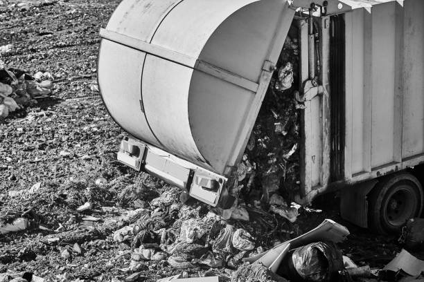 Truck unloading garbage on an open air dump. Waste recycling