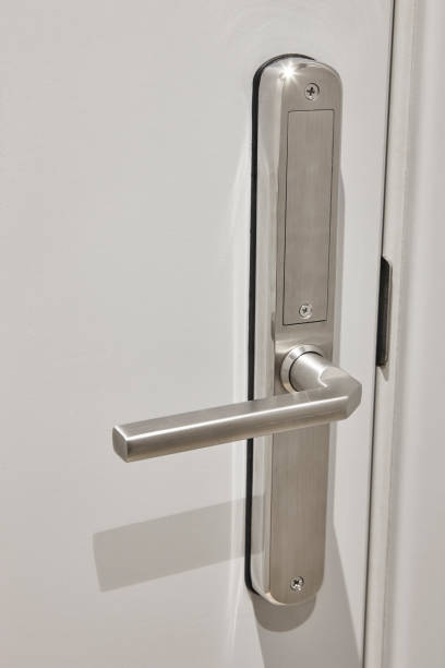 istock Metallic door handle on a white door. Hotel room interior 2187988415