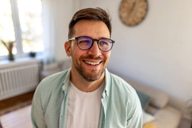 istock Smiling Man With Glasses Enjoying a Bright Day Indoors 2187988434
