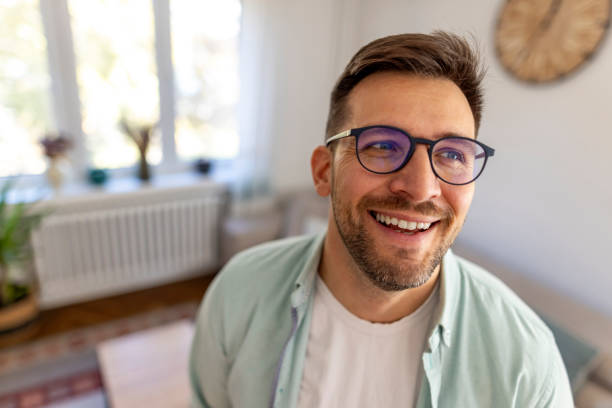 istock Smiling Man With Glasses Inside Brightly Lit Modern Home 2187988437