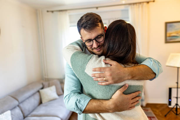 istock Heartfelt Hug Between Two People in Cozy Living Room Setting 2187988721
