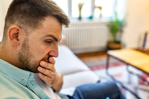 istock Thoughtful Man Sitting in Living Room Showing Contemplative Expression 2187988895