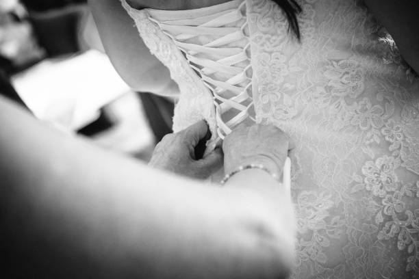 istock A Mother's Loving Touch: Tying Her Daughter's Dress 2187990653