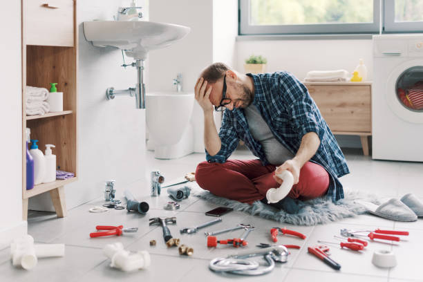 istock Confused man trying to fix the bathroom sink by himself 2187991132