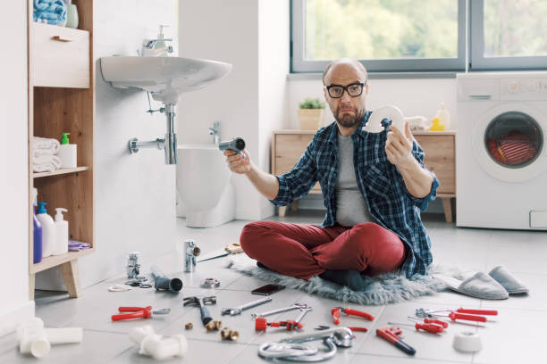 istock Confused man trying to fix the bathroom sink by himself 2187991155