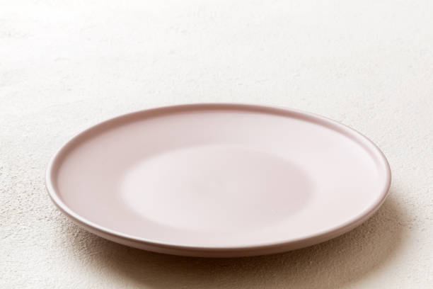 istock Perspective view of empty pink plate on cement background. Empty space for your design 2187991193