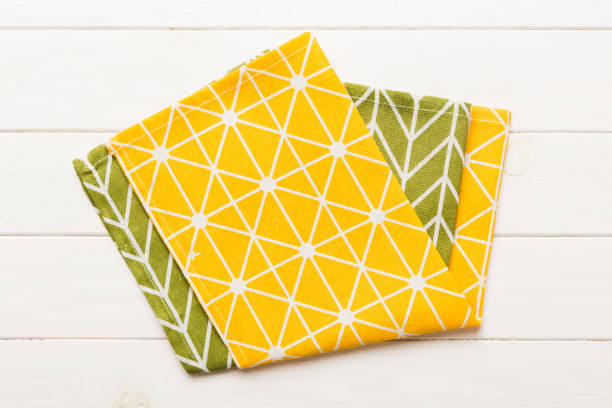 istock top view with yellow empty kitchen napkin isolated on table background. Folded cloth for mockup with copy space, Flat lay. Minimal style 2187991283