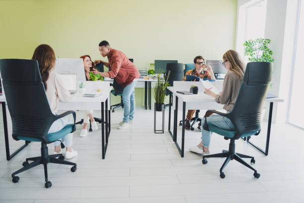 istock Full body portrait of young successful colleagues communicate use computer workplace business center office indoors 2187991377