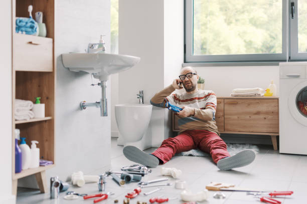 istock Frustrated man sitting on the floor and calling a plumber 2187991429
