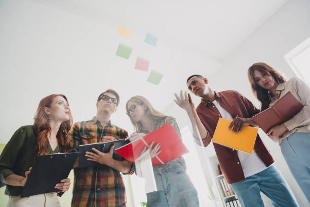 istock Photo of corporate colleagues concentrated on searching problem inside new project using stickers before release the solution at office 2187991495