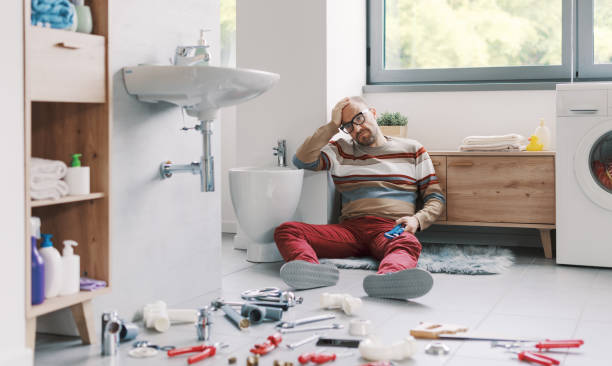 istock Desperate man unable to fix his broken sink 2187991510