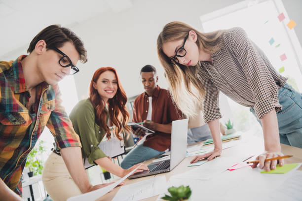 istock Photo of pretty young colleagues working process startup project team coworking successful nice light office 2187991626