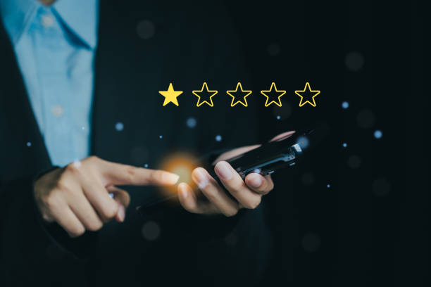 istock person holding smartphone with rating system displayed, indicating feedback. image conveys sense of evaluation and technology 2187991670