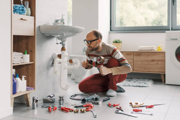 istock Inexpert man fixing his sink drain using adhesive tape 2187991815