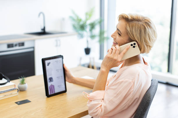 istock Woman shopping online using tablet and smartphone at home 2187991917