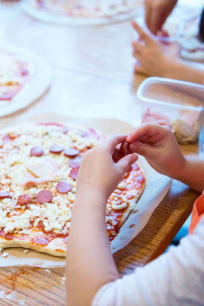 istock Children participate cooking master class. Culinary courses for children. Cooking pizza. 2187992517