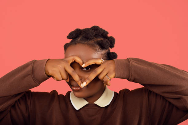 istock Young lady making a heart sign 2187993216