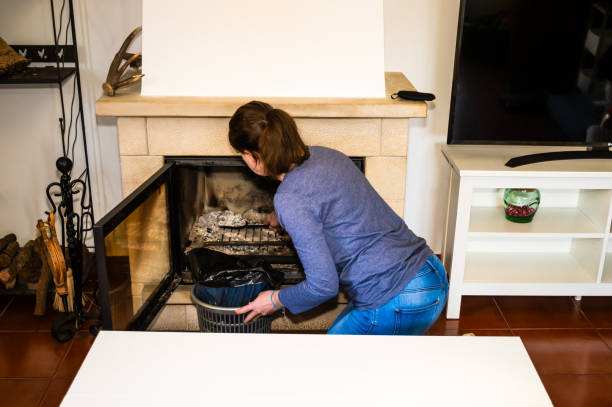 A woman cleaning the fireplace