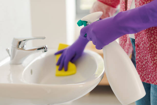 istock Housewife cleaning the bathroom sink using spray detergent 2187995511