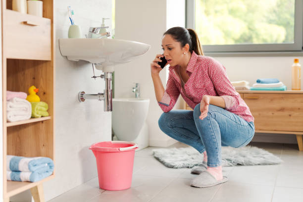 istock Woman calling a professional plumber at home 2187996073