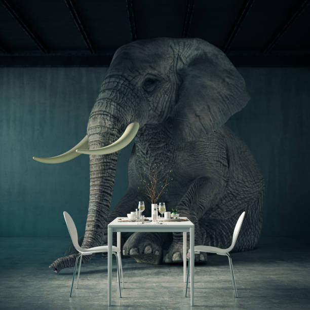 istock Huge elephant sitting at dining table in modern apartment 2187996543