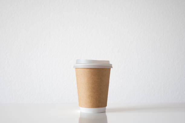 istock Empty, plastic, generic take-away coffee cup with brown cardboard paper wrapping, isolated on white. Close up shot, no branding, no logos, no people 2187997266