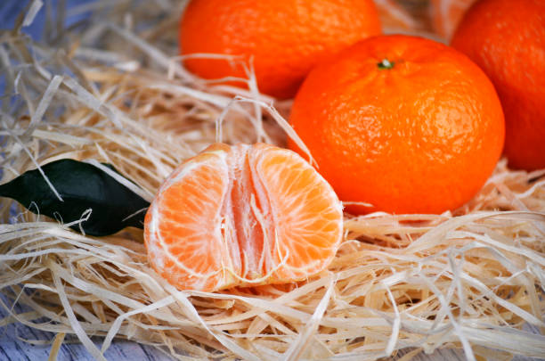 istock fresh mandarins with leafs on white wooden table 2187999452