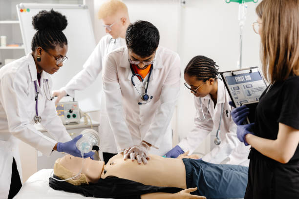 istock Group of people learning how to make first aid heart compressions with dummies during the training 2188000294