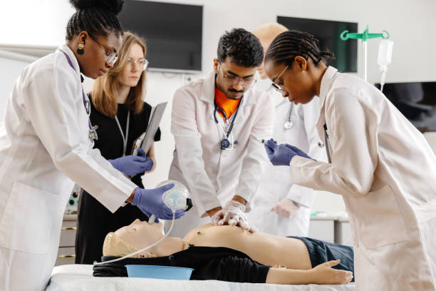 istock Group of people learning how to make first aid heart compressions with dummies during the training 2188000310