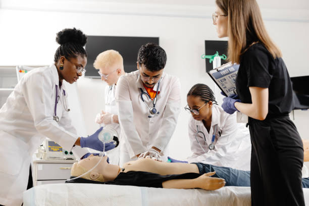 istock Group of people learning how to make first aid heart compressions with dummies during the training 2188000311