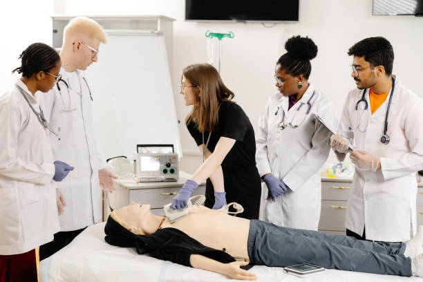 istock Instructor teaching first aid cardiopulmonary resuscitation course and use of automated external defibrillator workshop 2188000312