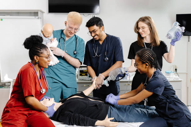 istock Group of doctors standing at the bed with mannequin at first aid training course 2188000451