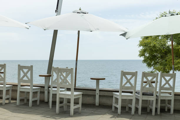 Tables with umbrellas on the beach, cafes