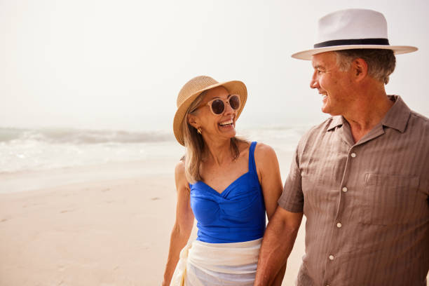 istock Affectionate senior couple on beach, holding hands and smiling 2188002567