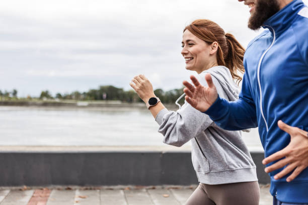 istock Smiling Couple Jogging Together in the Fresh Air 2188002589
