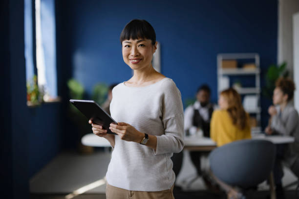 istock Happy Asian businesswoman using touchpad in the office. 2188005099