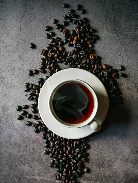 Coffee cup and coffee beans on gray background, Black coffee cup aromatic, top view