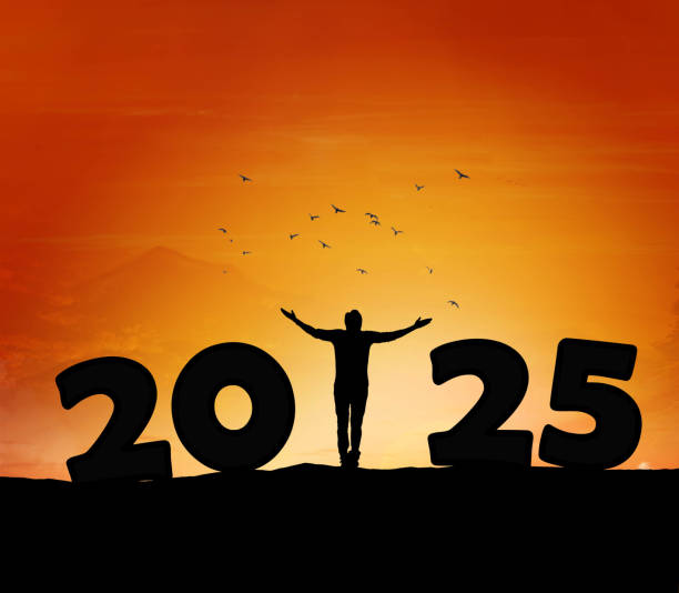 istock 2025, silhouette of a successful man standing at hill raising hands 2188006214