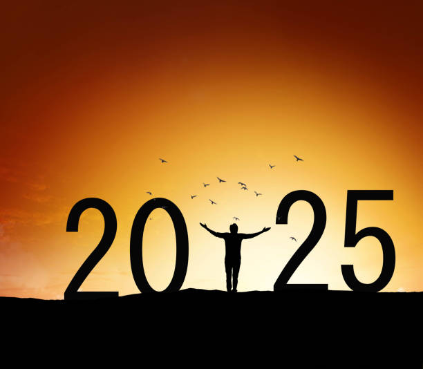 istock 2025, silhouette of a successful man standing at hill raising hands 2188006428