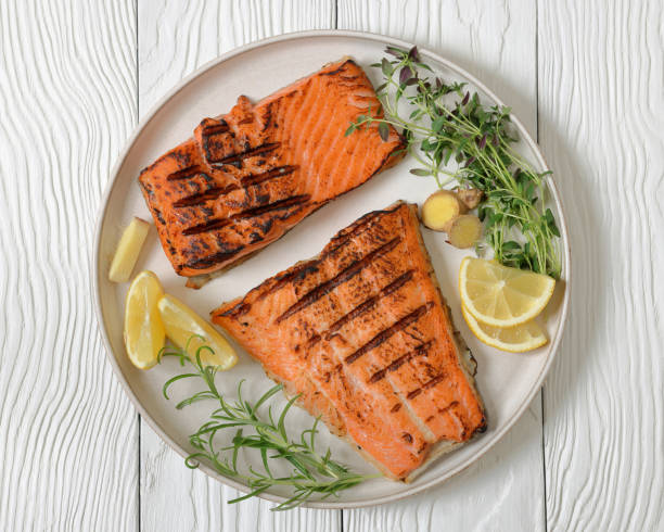 istock grilled salmon fish fillet with herbs, top view 2188006466