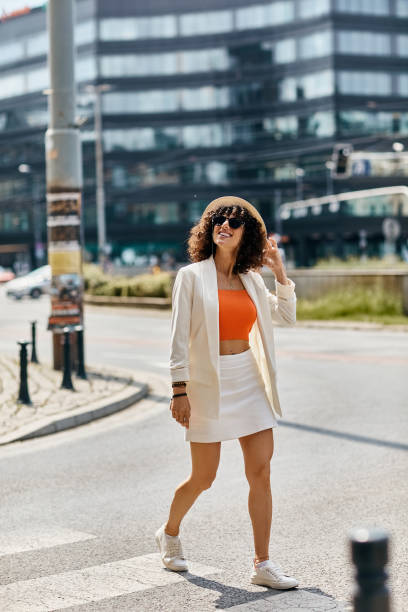 istock Young woman enjoying a sunny day while exploring European city streets with style 2188009873