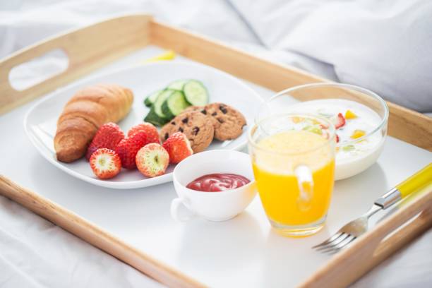 istock A delicious breakfast in bed with croissants, fruit, and yogurt 2188010546