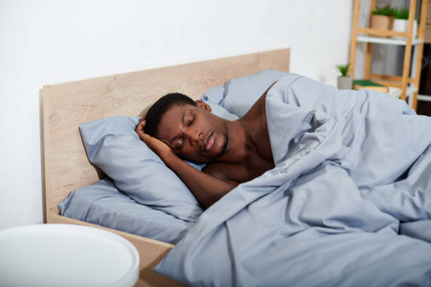 istock Handsome young man peacefully resting in a cozy bedroom with soft bedding on a calm morning 2188010862