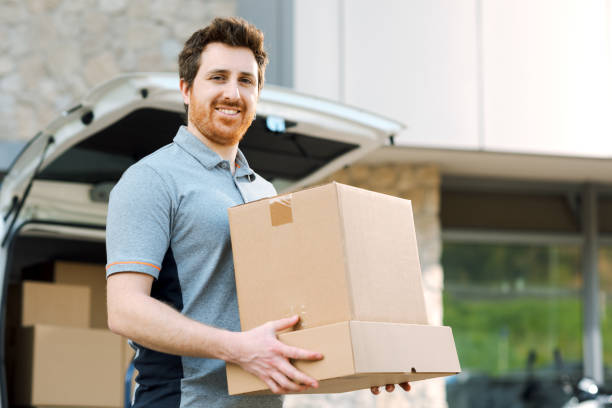 istock Portrait of a delivery guy carrying boxes 2188011900