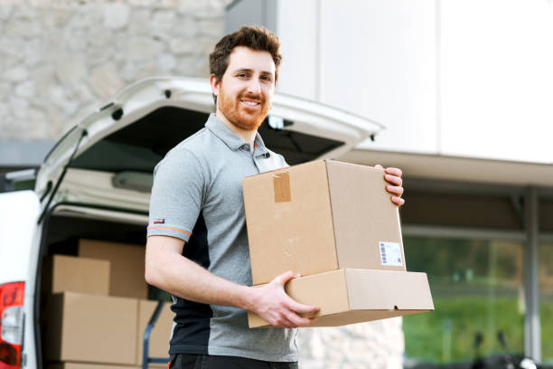 istock Portrait of a delivery guy carrying boxes 2188011955