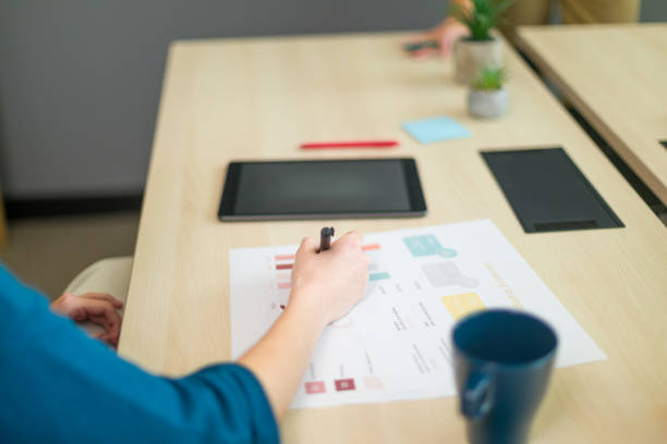 istock Businesswoman analyzing financial charts and data at office desk 2188012181