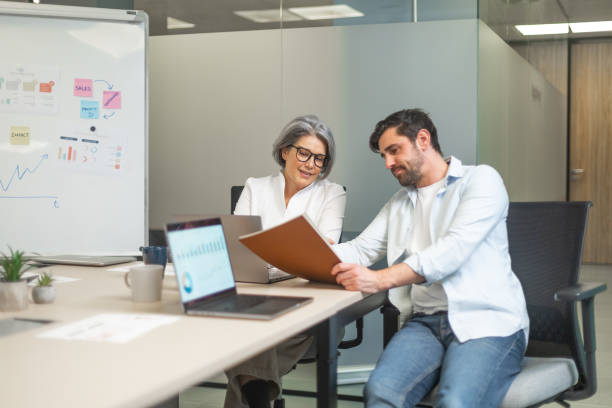 istock Business people working together in modern office analyzing financial charts 2188012291