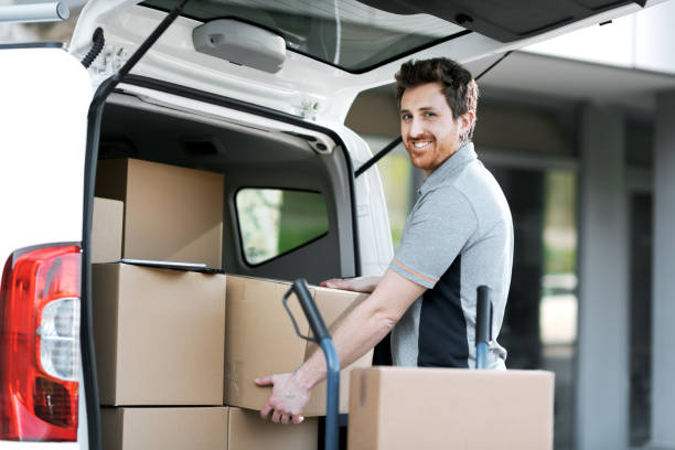 istock Professional delivery man loading packages on a hand truck 2188012808